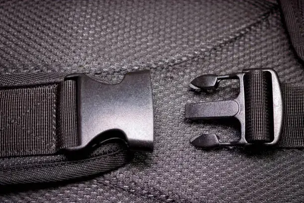 Black plastic buckle on the backpack.