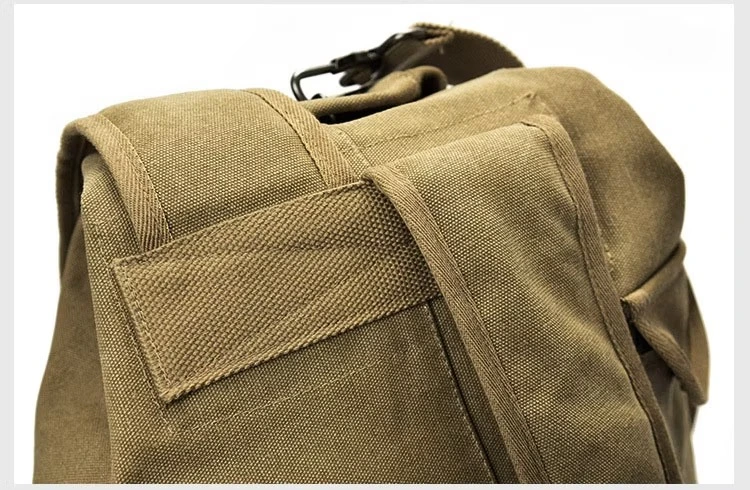 Close-up of the backpack's top handle and reinforced stitching near the shoulder strap.