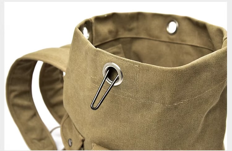 Open top view of the duffel backpack showing metal grommets and a hook-style closure.