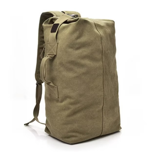 canvas duffel backpack standing upright with shoulder straps and side handles.