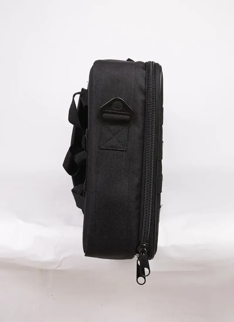Side view of a black tactical bag with a zipper, handle, and multiple straps