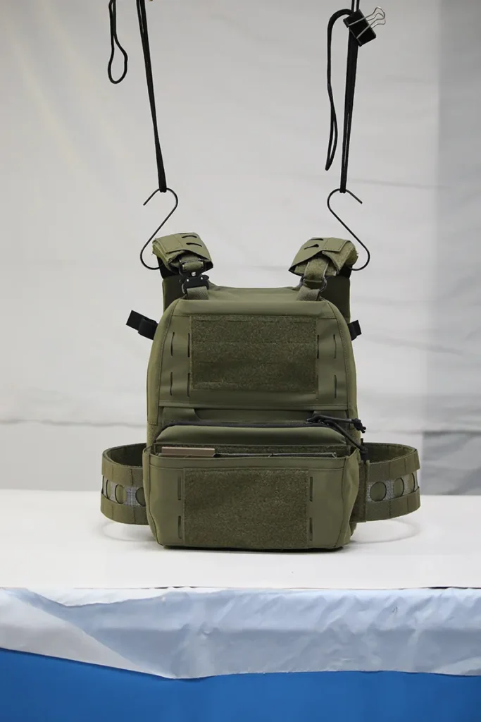 Green custom tactical vest with MOLLE webbing and modular pouches