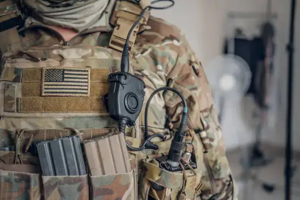 military man in USA army uniform with radio in his pocket.
